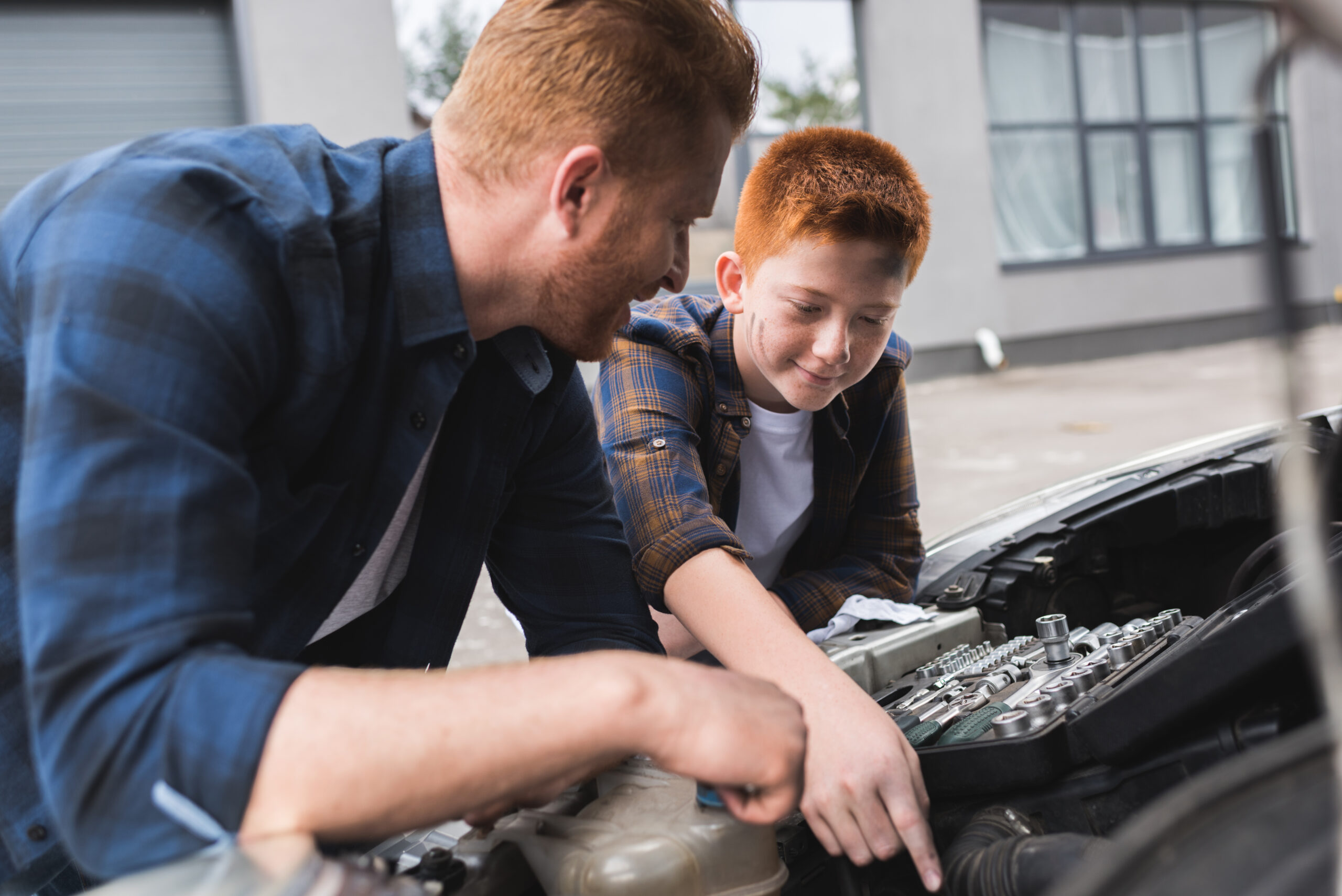 father and son working on car for father's day in leamington